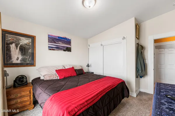 a bedroom with a bed and a couch