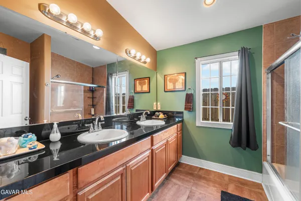 a bathroom with a sink double vanity and a mirror