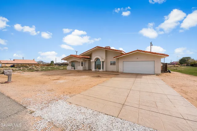a house with swimming pool in front of it