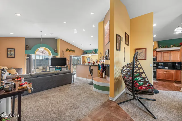 a living room filled with furniture and a chandelier
