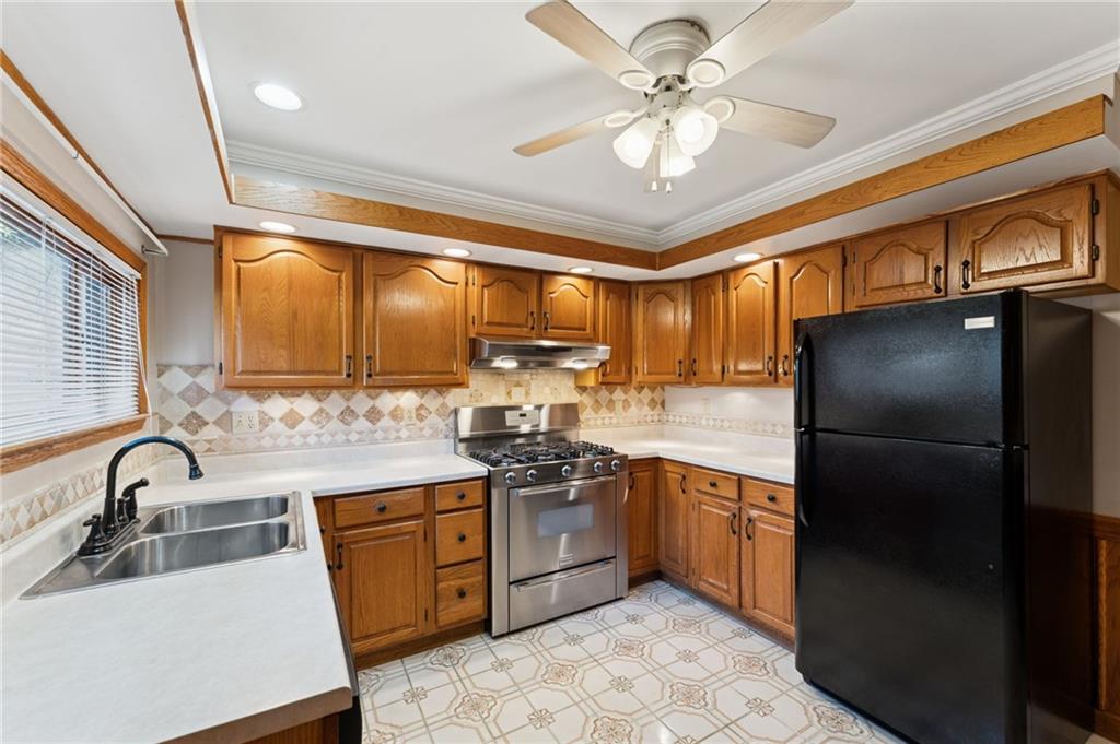 28 Gregory Street Pittsburgh, PA 15203 - Photo 11 of 44 a kitchen with stainless steel appliances granite countertop a sink a stove a refrigerator cabinets and furniture