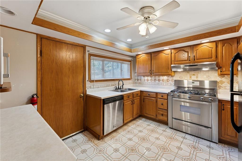 28 Gregory Street Pittsburgh, PA 15203 - Photo 12 of 44 a kitchen with stainless steel appliances granite countertop a stove sink and cabinets