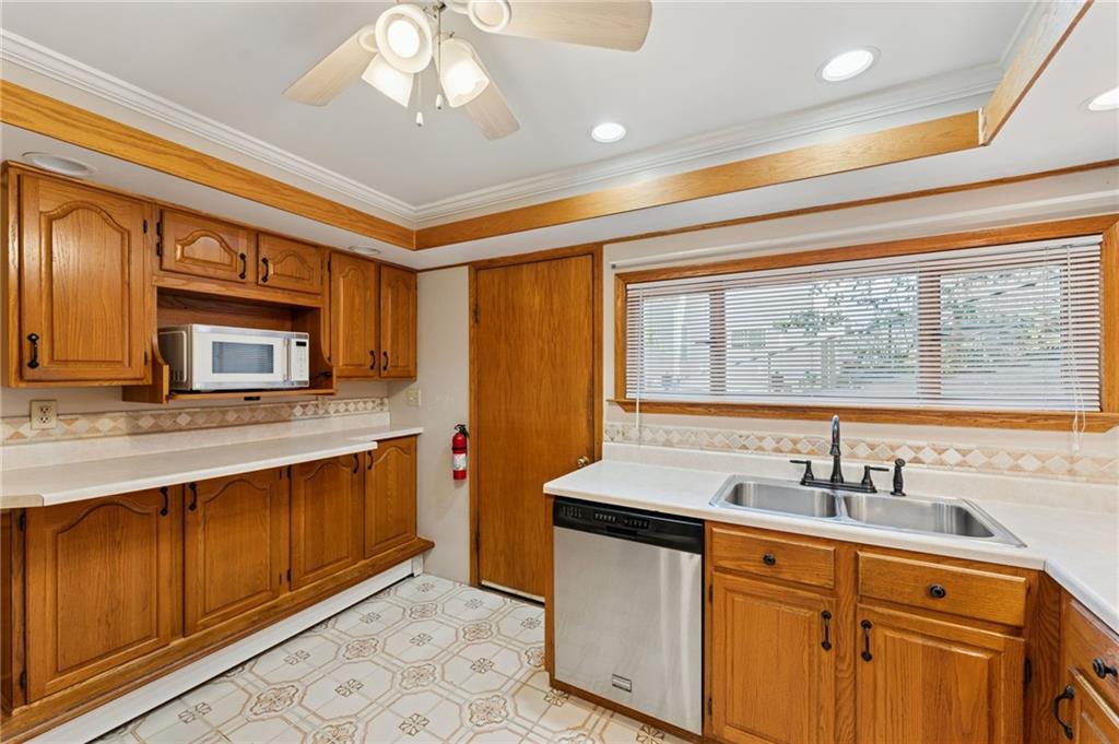 28 Gregory Street Pittsburgh, PA 15203 - Photo 13 of 44 a kitchen with stainless steel appliances granite countertop a sink and cabinets