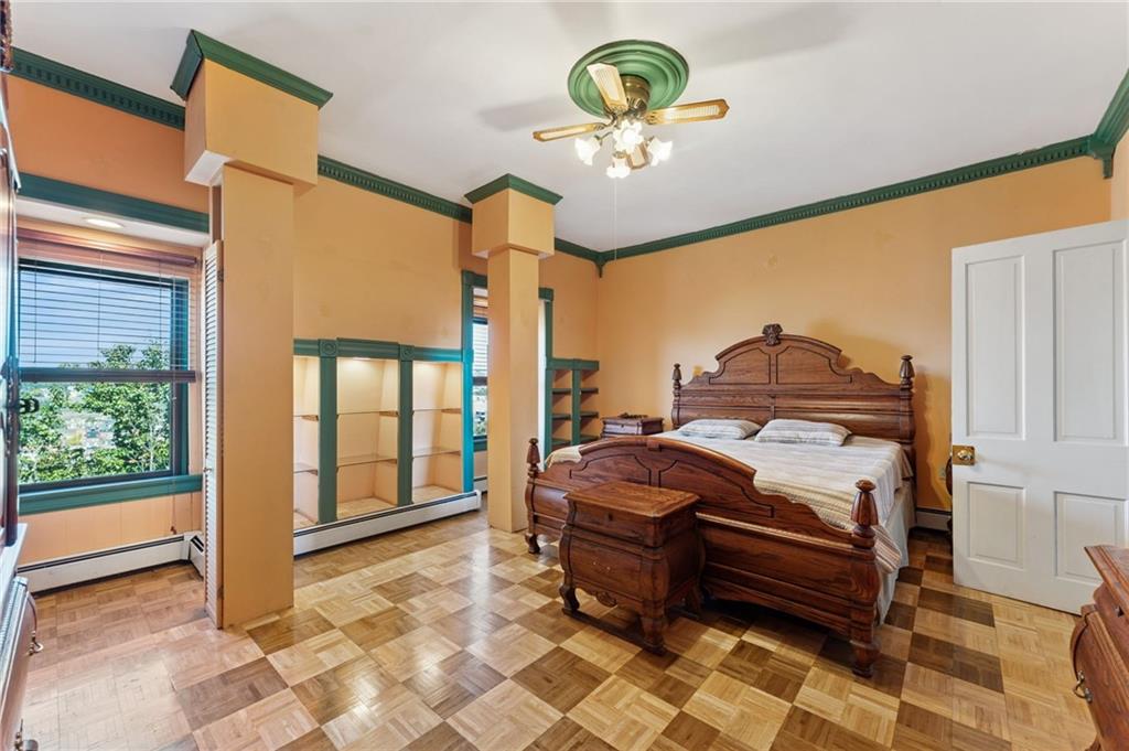 28 Gregory Street Pittsburgh, PA 15203 - Photo 28 of 44 a bedroom with a bed and a chandelier