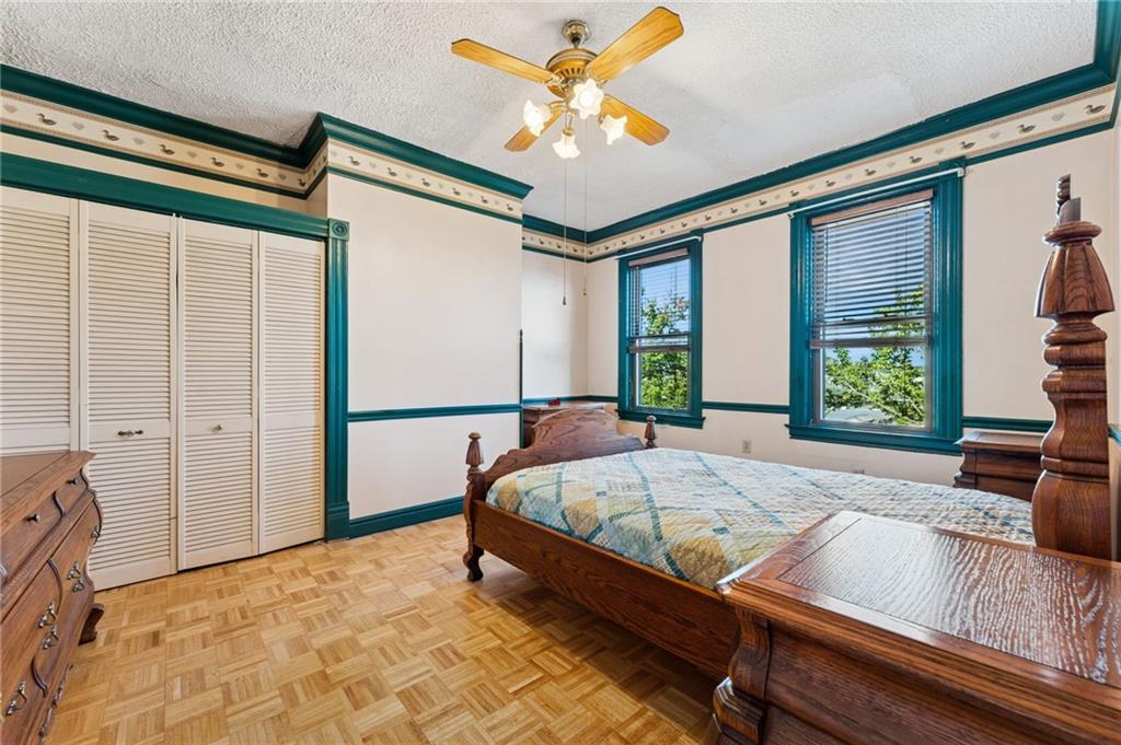 28 Gregory Street Pittsburgh, PA 15203 - Photo 32 of 44 a bed sitting in a bedroom next to a window