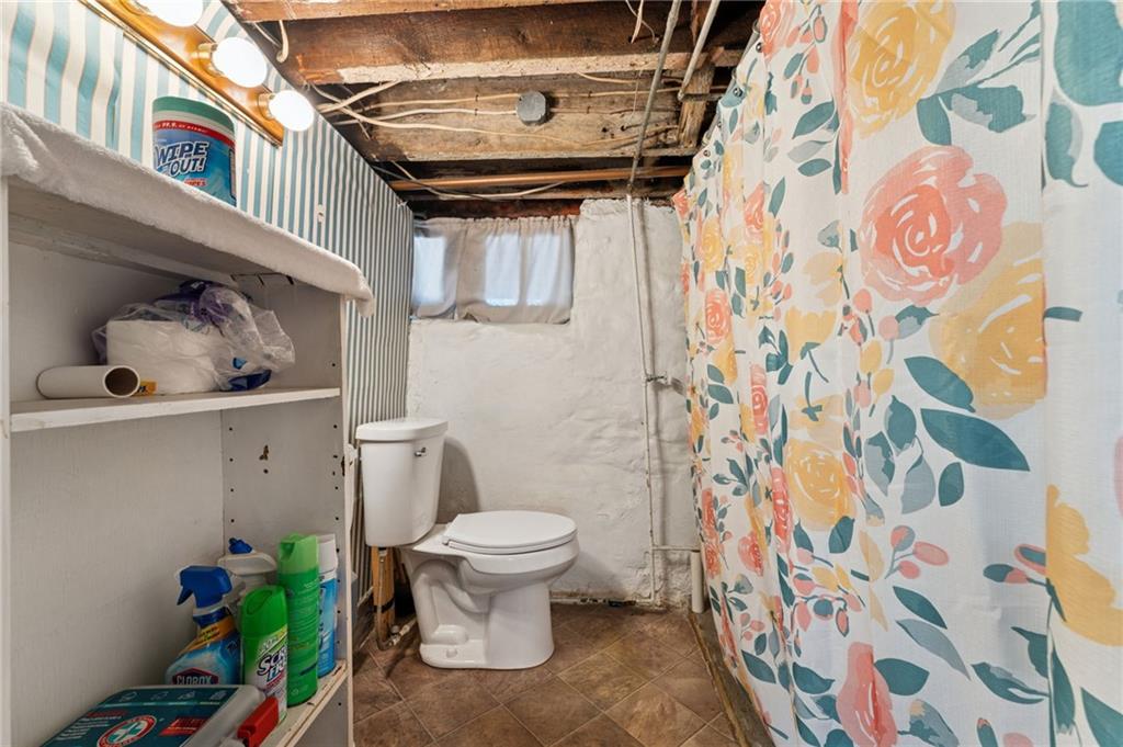 28 Gregory Street Pittsburgh, PA 15203 - Photo 35 of 44 a white toilet sitting next to a shower curtain