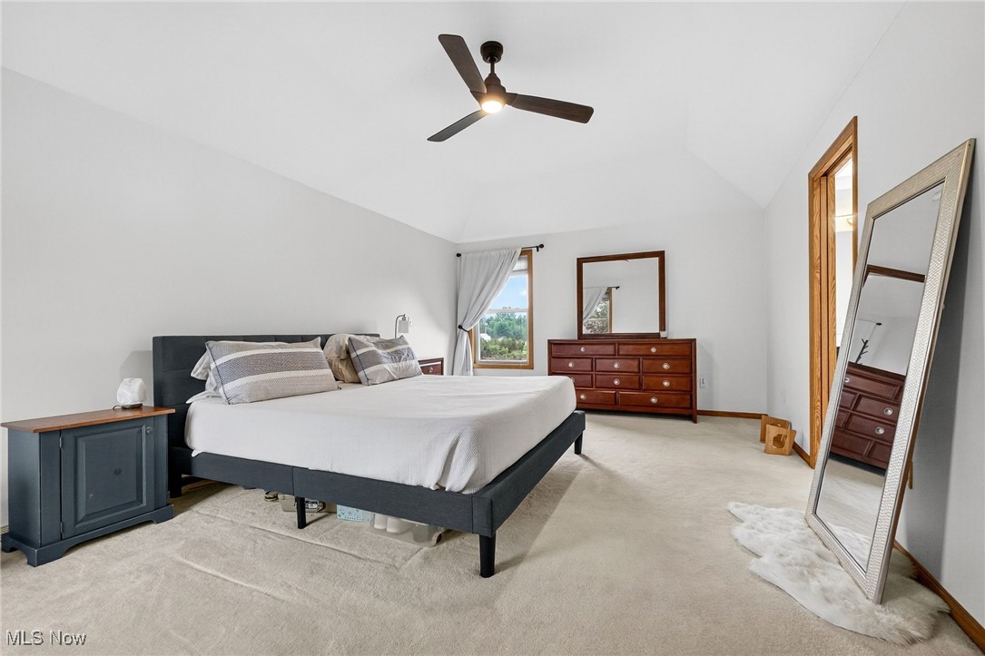 35748 Mills Road Avon, OH 44011 - Photo 20 of 44 Bedroom with vaulted ceiling, light carpet, and a ceiling fan