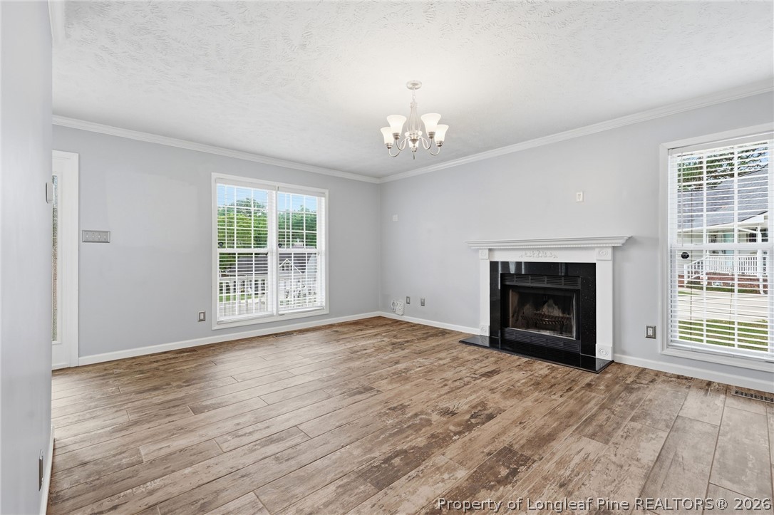 5113 Archer Road Hope Mills, NC 28348 - Photo 11 of 41 a view of empty room with a fireplace cabinet and windows