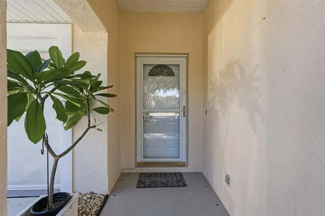 a vase of flowers sitting on a table in front of a door