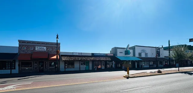 a view of street along with retail shop and buildings