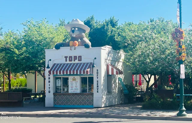 a view of the patio with table and chairs under an umbrella