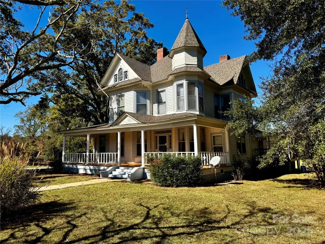 a front view of a house with swimming pool having outdoor seating