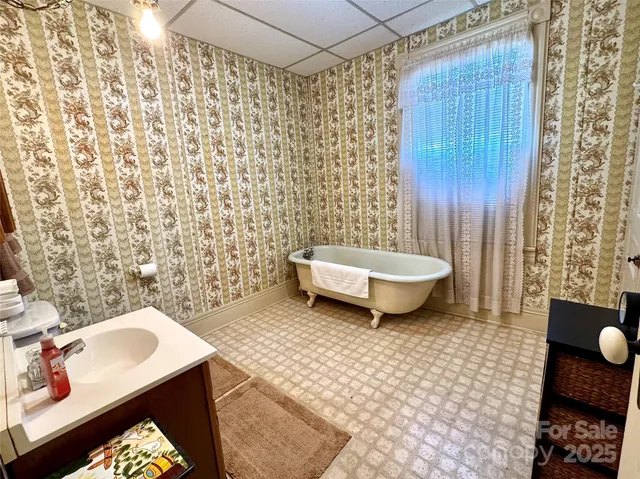 a view of an empty room with a fireplace and a window