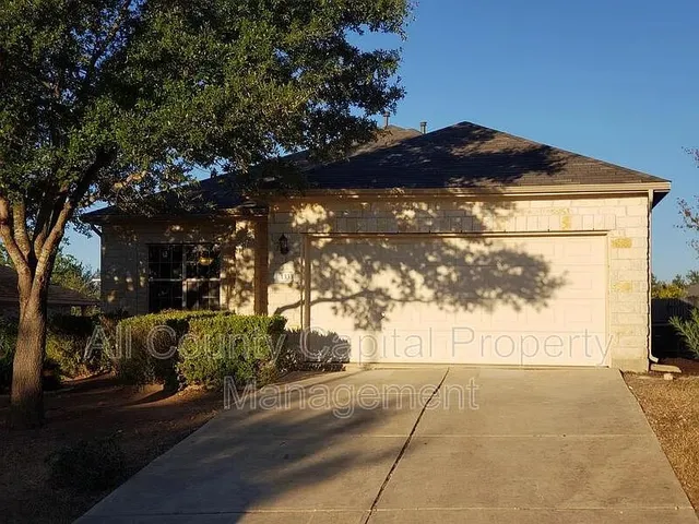a view of entrance gate of house and car parked
