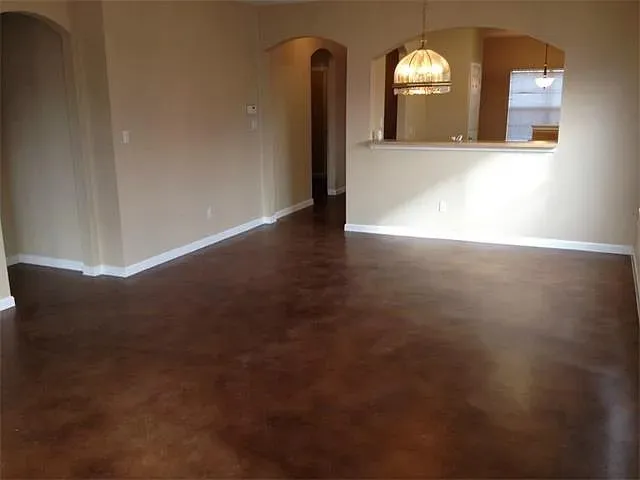 a view of a livingroom with wooden floor and a window