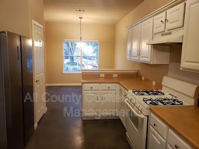 a kitchen with stainless steel appliances granite countertop a stove a sink dishwasher and a refrigerator