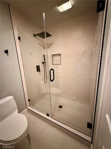 a bathroom with a shower and toilet