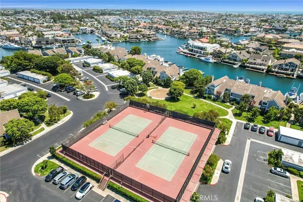an aerial view of a residential houses with outdoor space and lake view