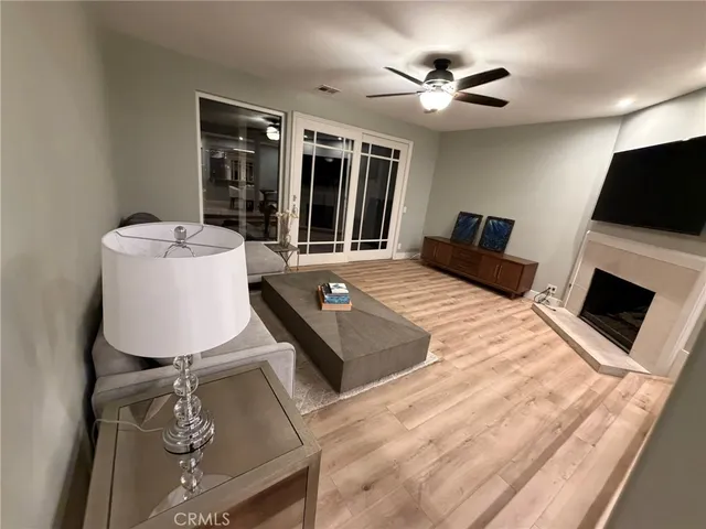 a living room with furniture fireplace and flat screen tv