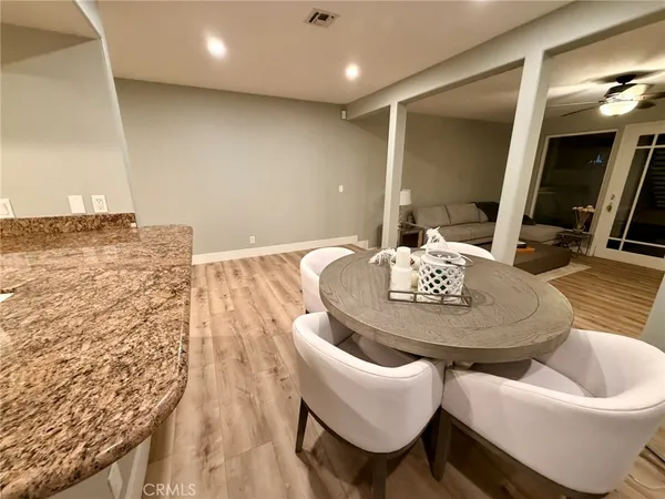 a dining room with furniture and wooden floor