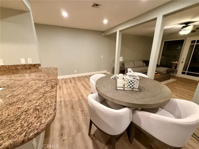 a dining room with furniture and wooden floor