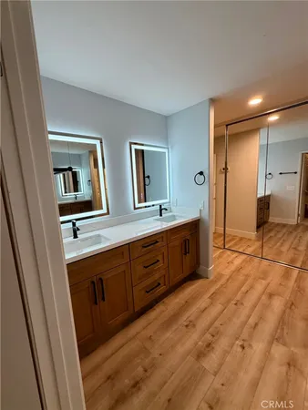a spacious bathroom with a double vanity sink and a mirror