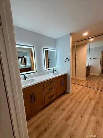 a spacious bathroom with a double vanity sink and a mirror