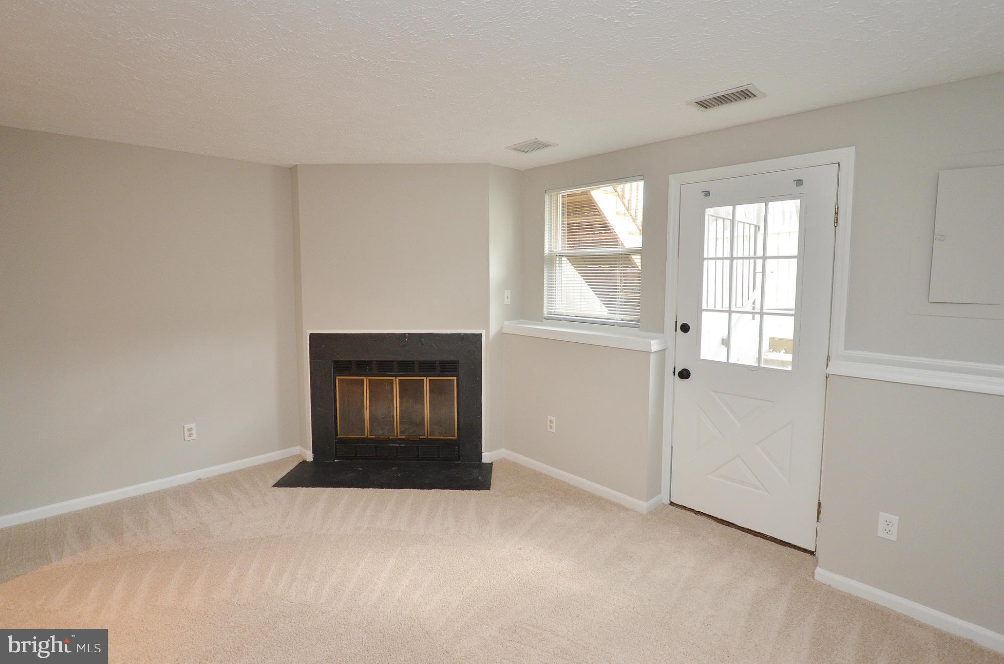 1617 Fieldthorn Drive Reston, VA 20194 - Photo 16 of 30 Fireplace and walk-out entrance to yard