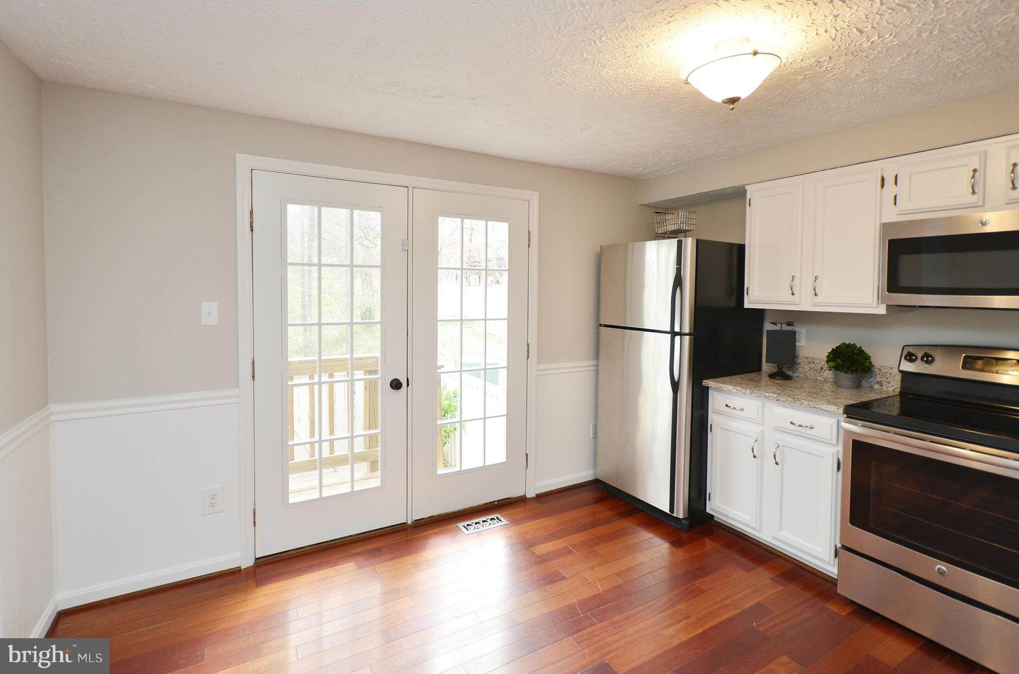 1617 Fieldthorn Drive Reston, VA 20194 - Photo 7 of 30 Kitchen w/ French doors lead to 2-tiered deck
