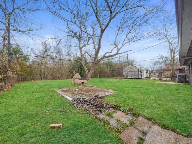a front view of a house with garden and trees