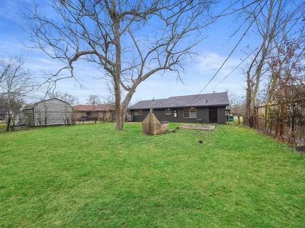 a view of house with backyard