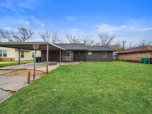a front view of a house with a yard and table