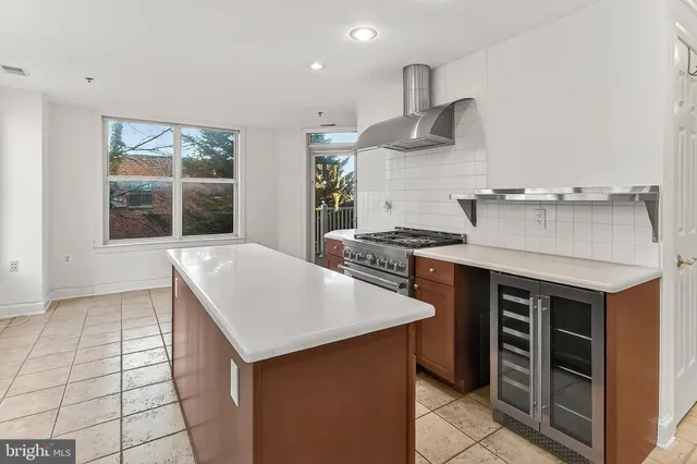 a view of an empty room with window and cabinet