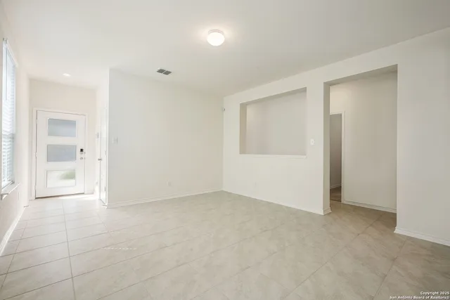 an empty room with windows and entrance