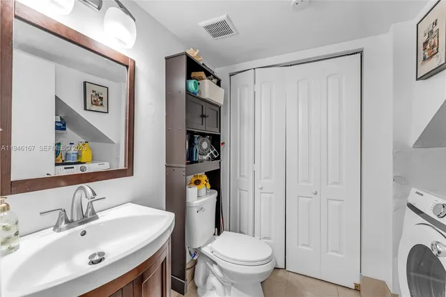 a bathroom with a toilet a sink and a mirror