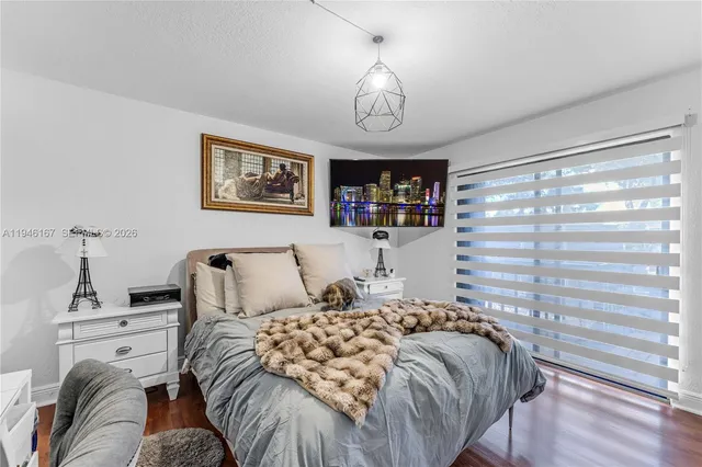 a bedroom with a bed and a chandelier