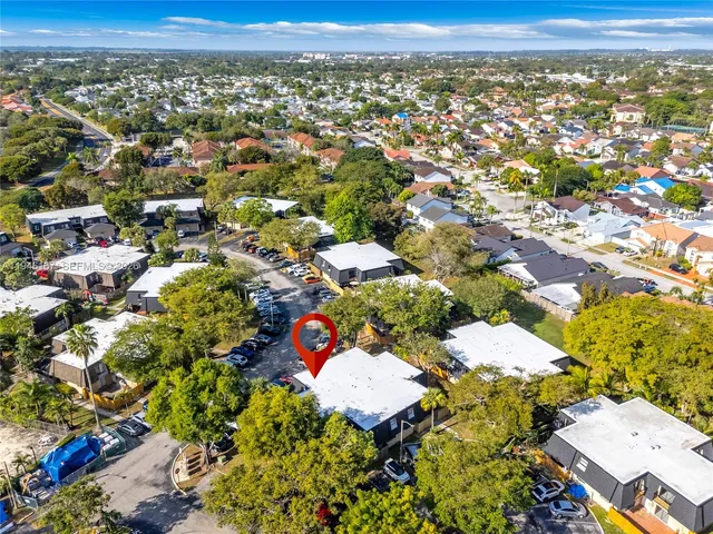 an aerial view of residential houses with outdoor space