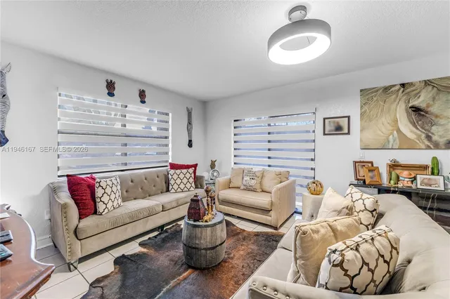 a living room with furniture and white walls