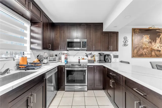 a kitchen with a sink stove top oven and cabinets