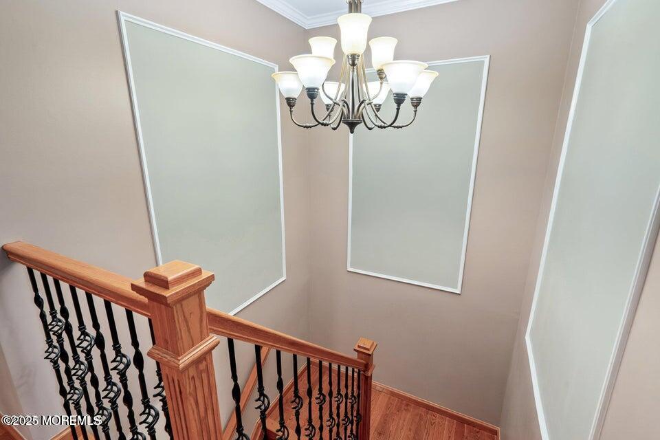 11 Desiree Court Howell, NJ 07731 - Photo 12 of 23 a view of a hallway with wooden floor and chandelier