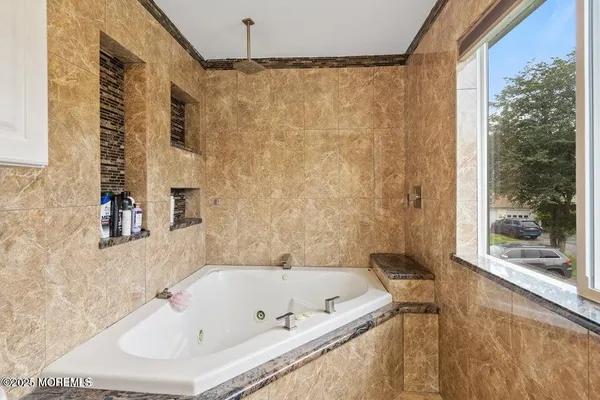 a bathroom with a tub and a shower