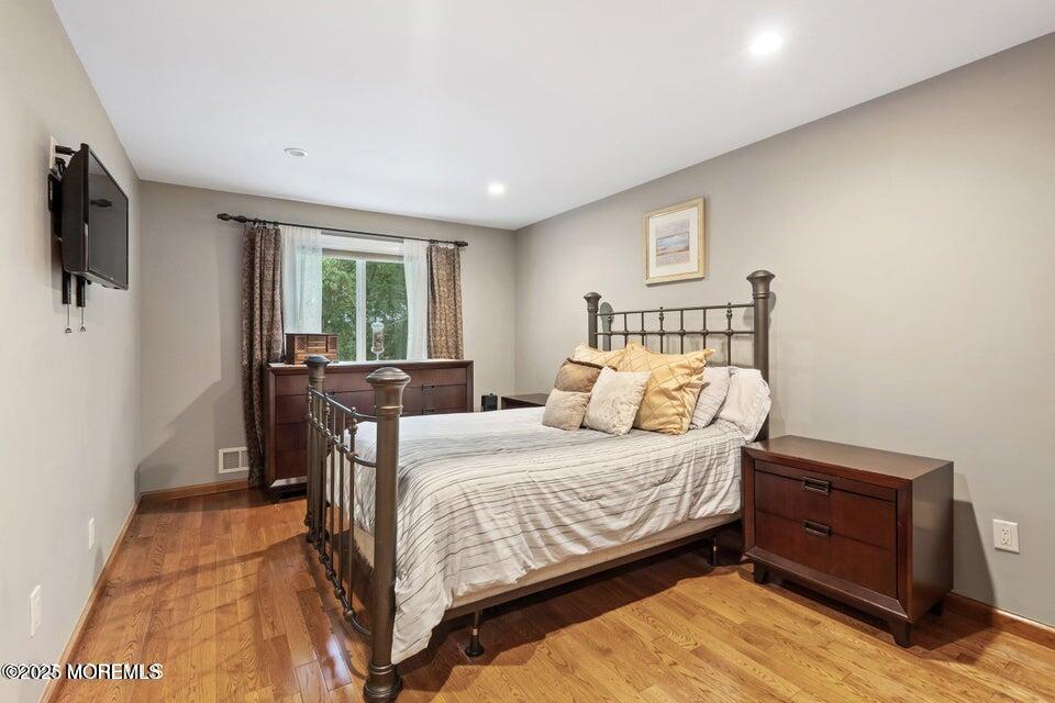 11 Desiree Court Howell, NJ 07731 - Photo 17 of 23 a bedroom with a bed and wooden floor