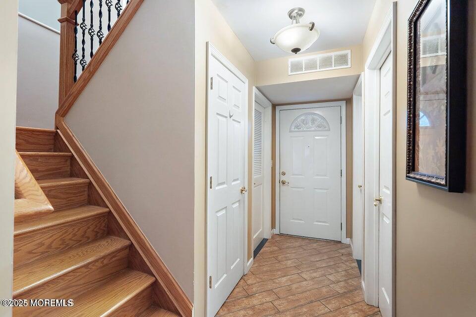 11 Desiree Court Howell, NJ 07731 - Photo 4 of 23 a view of a hallway with wooden floor and staircase