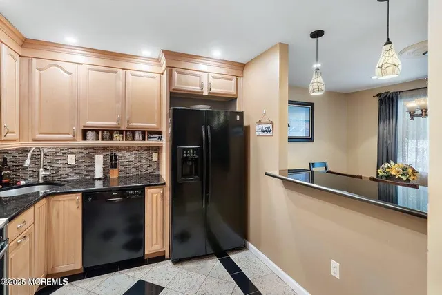 a kitchen with stainless steel appliances a sink and a refrigerator