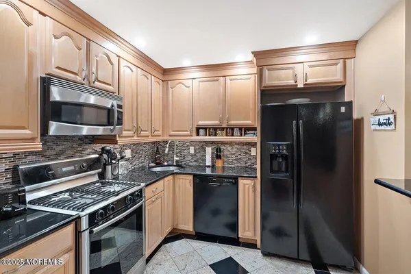a kitchen with a refrigerator stove and cabinets