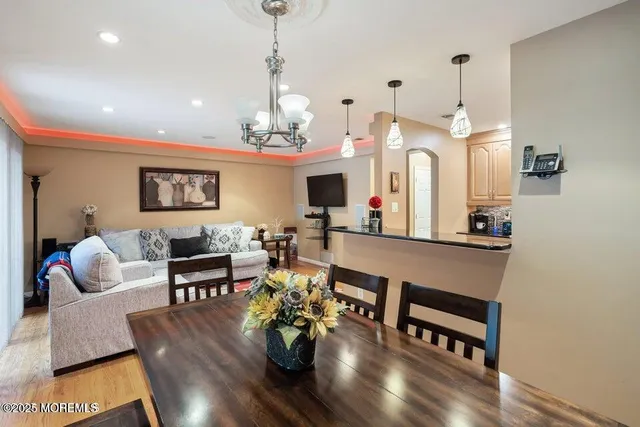 a living room with furniture a fireplace and a chandelier
