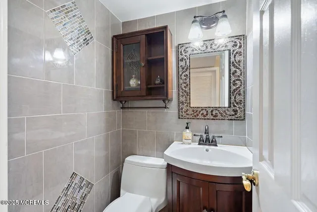 a bathroom with a sink toilet and mirror