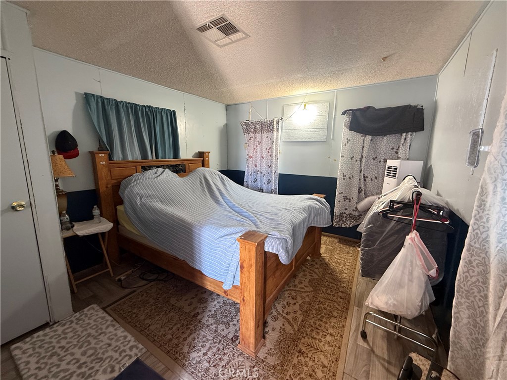 35030 Harvard Road Newberry Springs, CA 92365 - Photo 4 of 23 a bedroom with bed and wooden floor