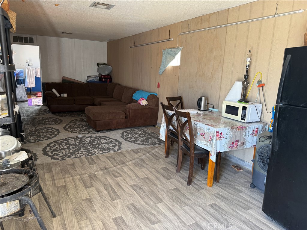 35030 Harvard Road Newberry Springs, CA 92365 - Photo 7 of 23 a living room with furniture and a flat screen tv