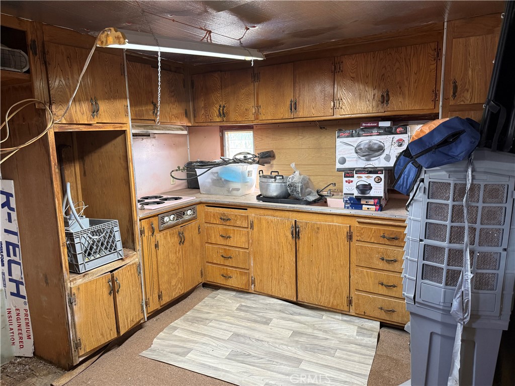 35030 Harvard Road Newberry Springs, CA 92365 - Photo 9 of 23 a kitchen with white cabinets and white appliances